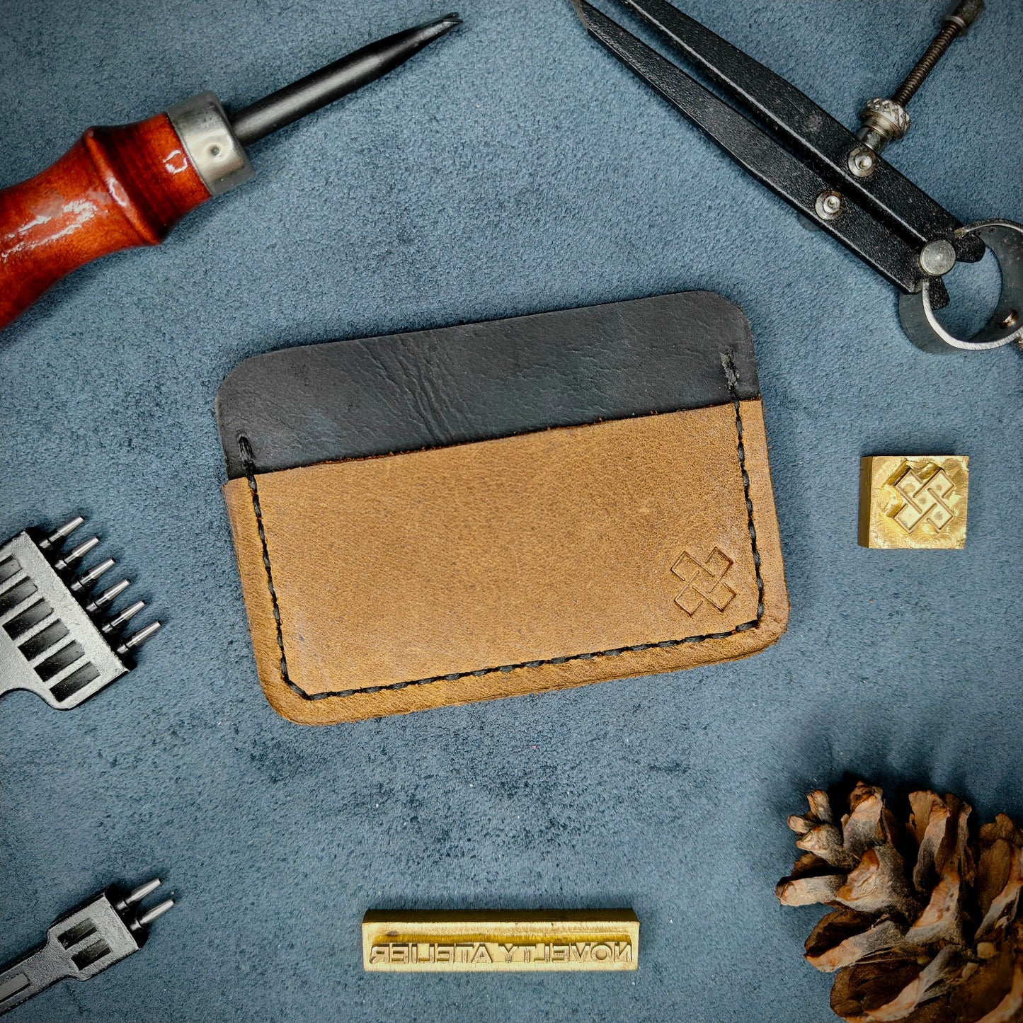 Back view of The Houdini minimalist leather card holder horizontal configuration by Novelty Atelier – features a clean, functional layout with the design logo subtly stamped into sandstorm full-grain leather. Accented with black saddle stitching for a timeless aesthetic.