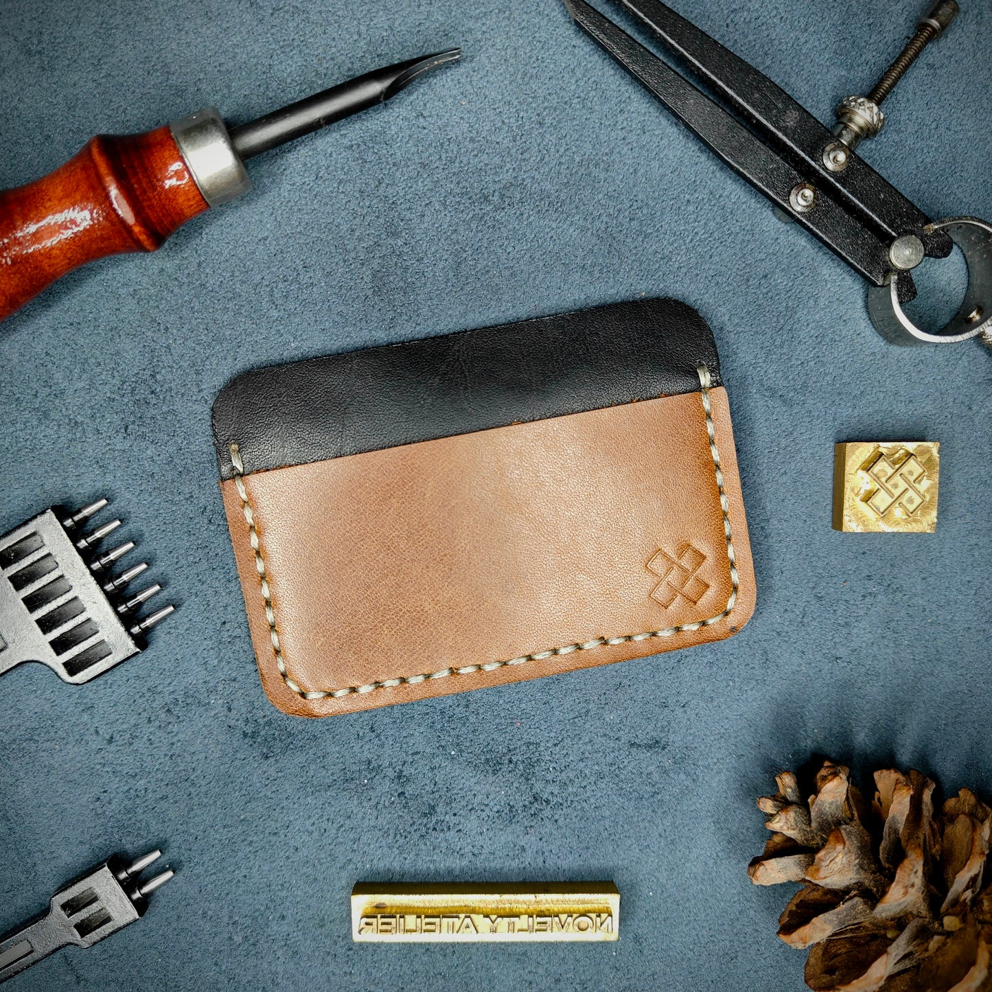 Back view of The Houdini minimalist leather card holder in horizontal configuration by Novelty Atelier – features a clean, functional layout with the design logo subtly stamped into Brown full-grain leather. Accented with off-white saddle stitching for a timeless aesthetic.